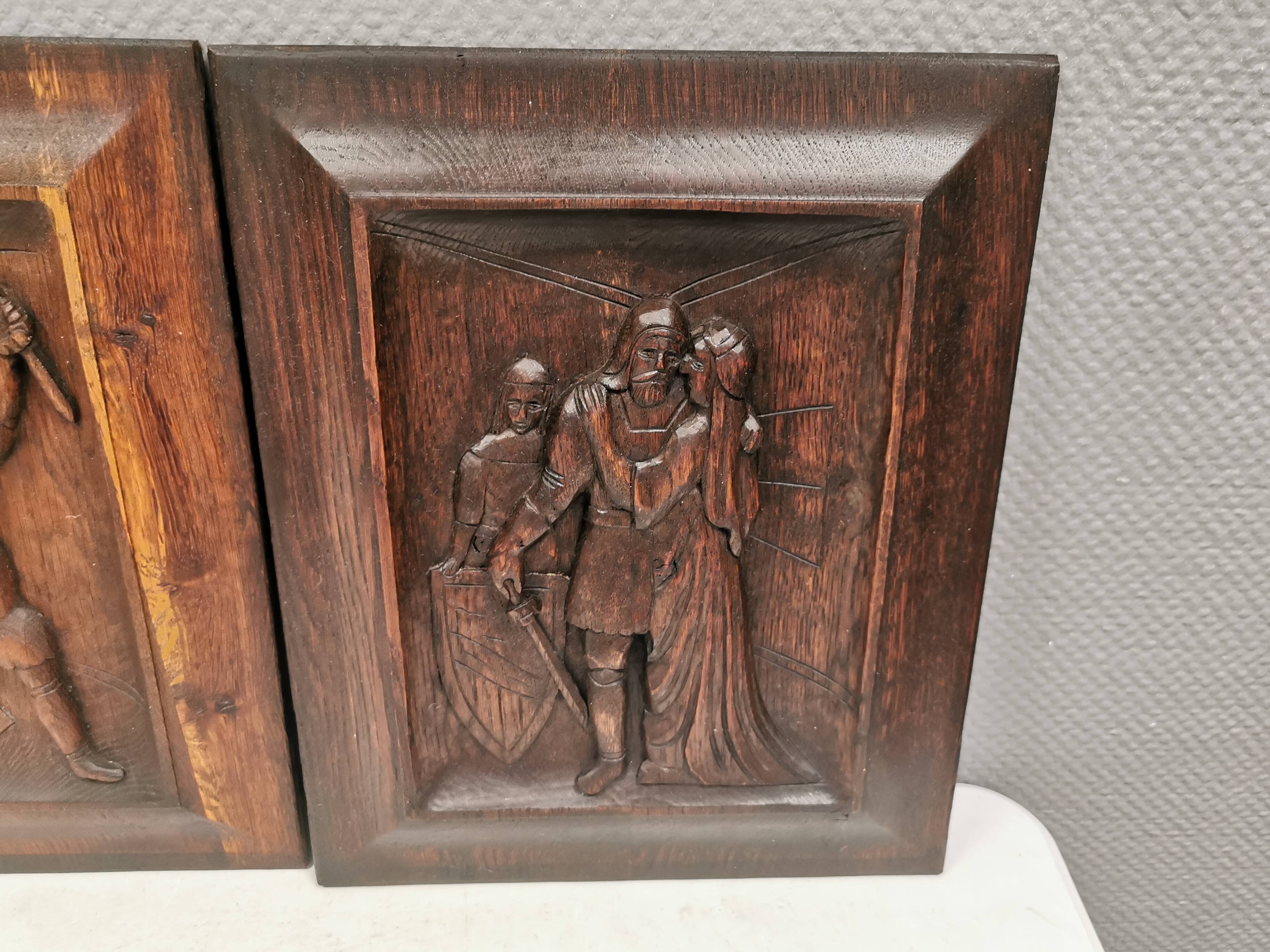 Four old wooden carvings to hang on the wall.