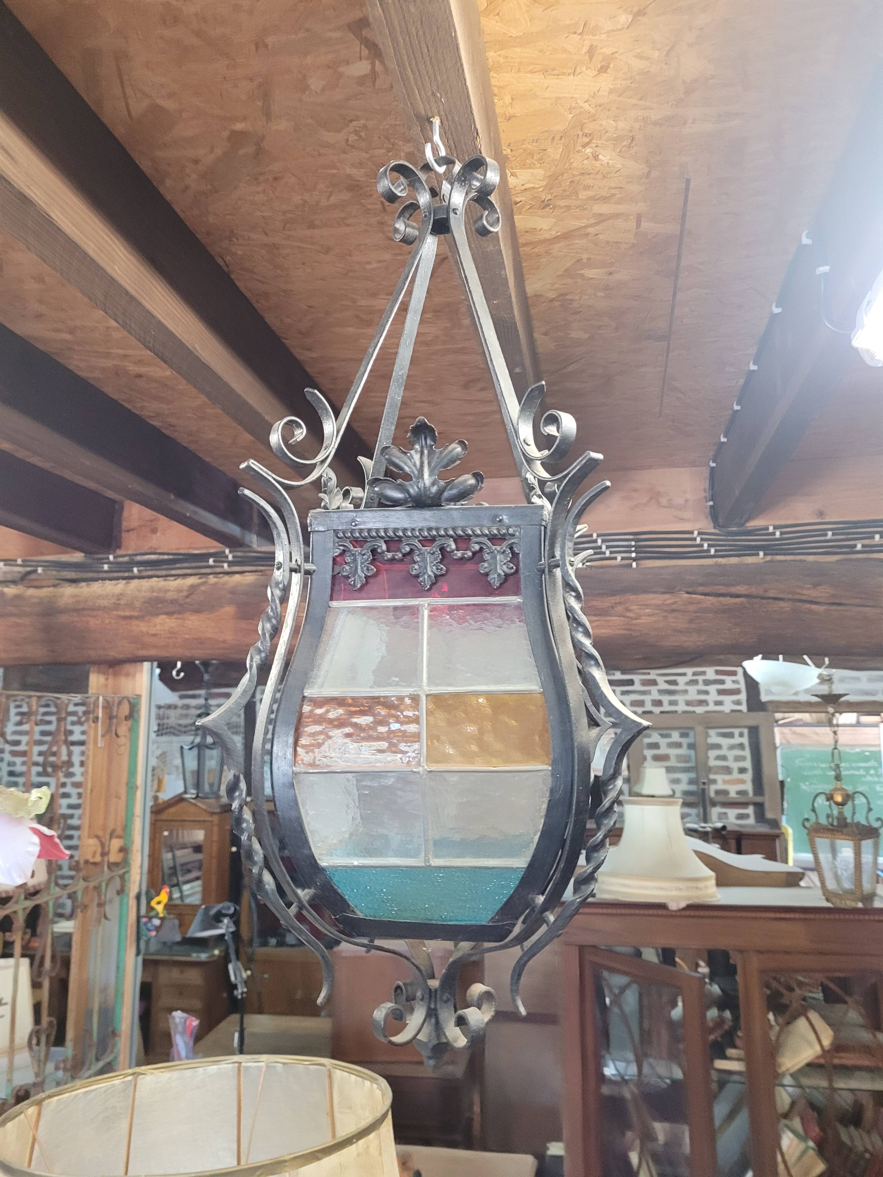 Wrought iron lantern with stained glass windows