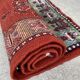 Vintage hand-knotted wool rug with polychrome decoration on a red, blue, green background 150 x 63 cm