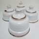 Four white enamelled metal cheese bells early twentieth century
