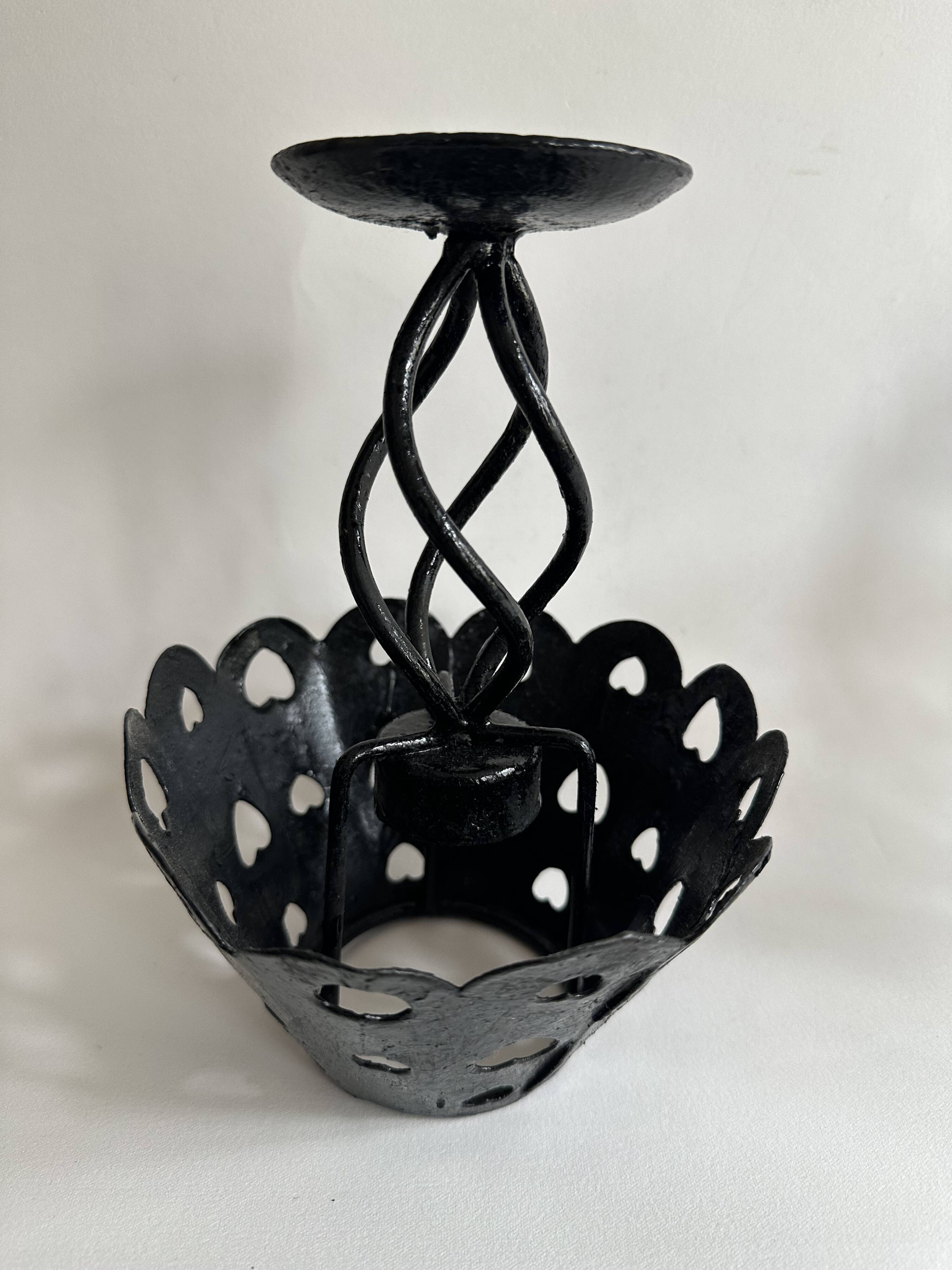Pair of black wrought iron lanterns with heart patterns, romantic style.