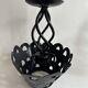 Pair of black wrought iron lanterns with heart patterns, romantic style.