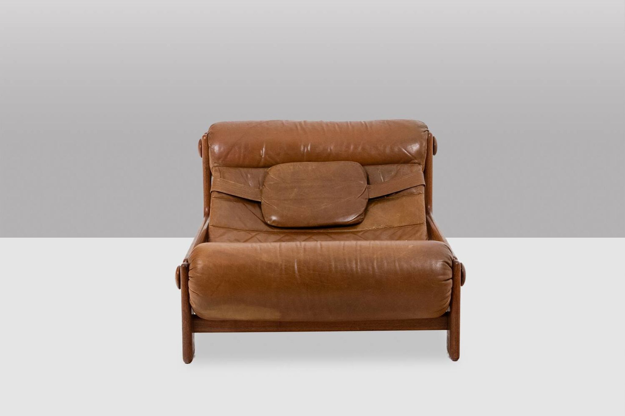 Lounge chair and ottoman, in blond elm and leather. 1970s