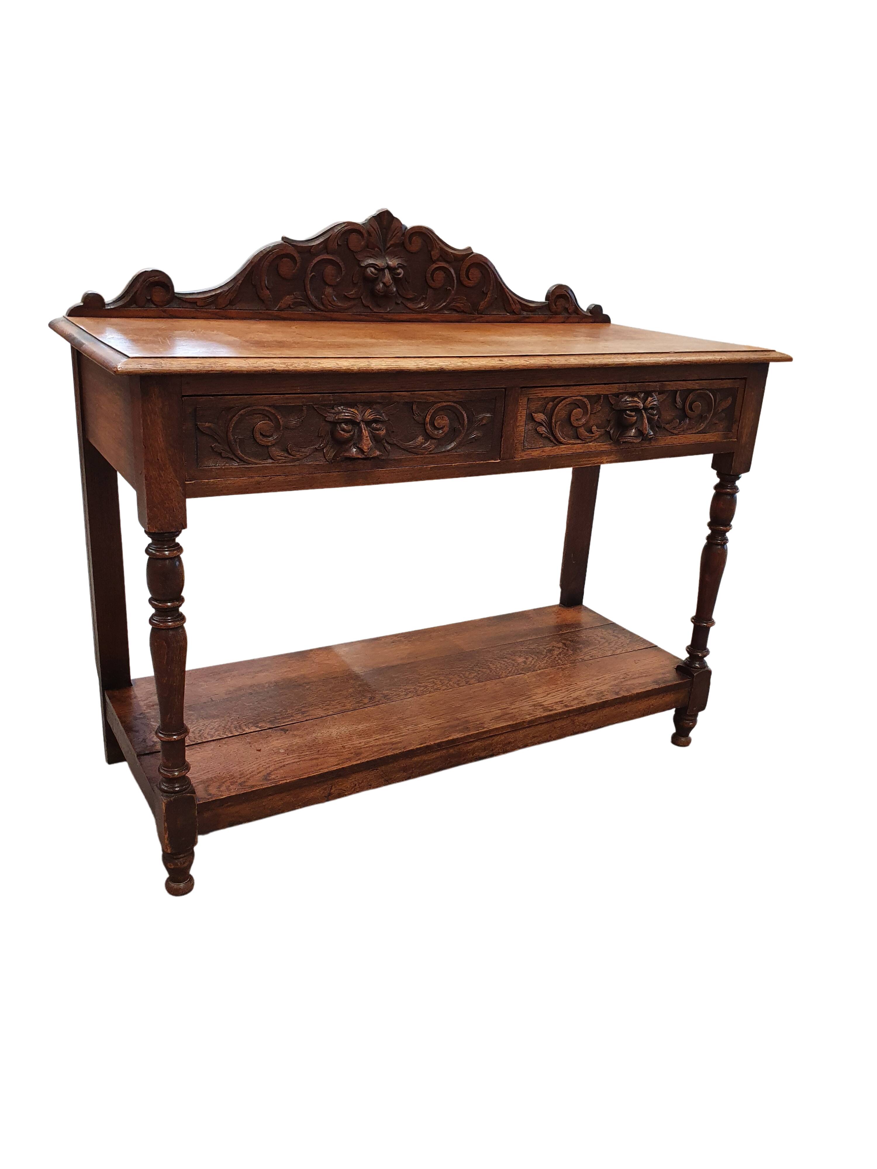 Victorian Gothic Oak side table, decorative carved round 1920. Green Mask decoration