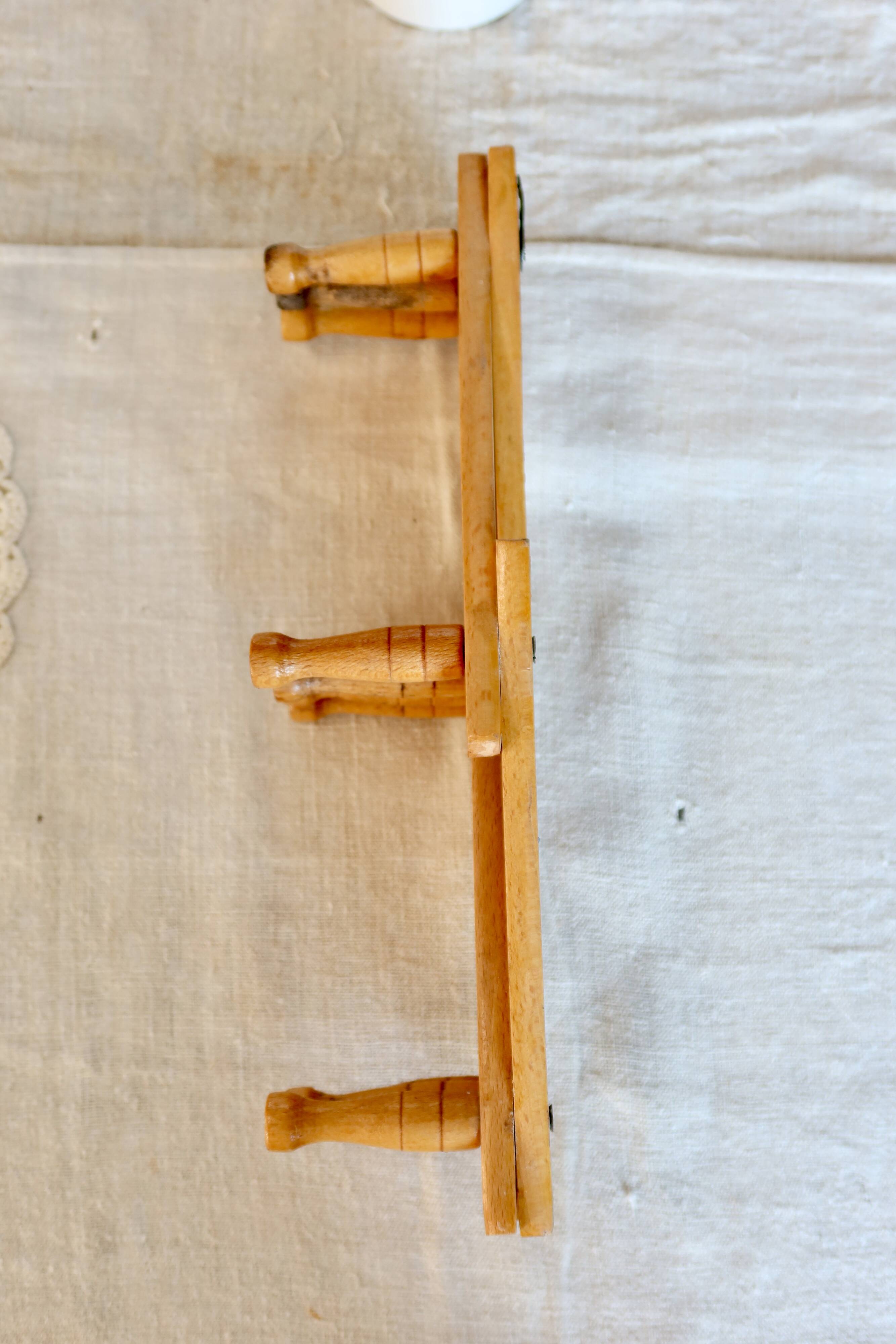 Vintage retractable wall-mounted coat rack made of pine wood