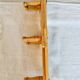 Vintage retractable wall-mounted coat rack made of pine wood