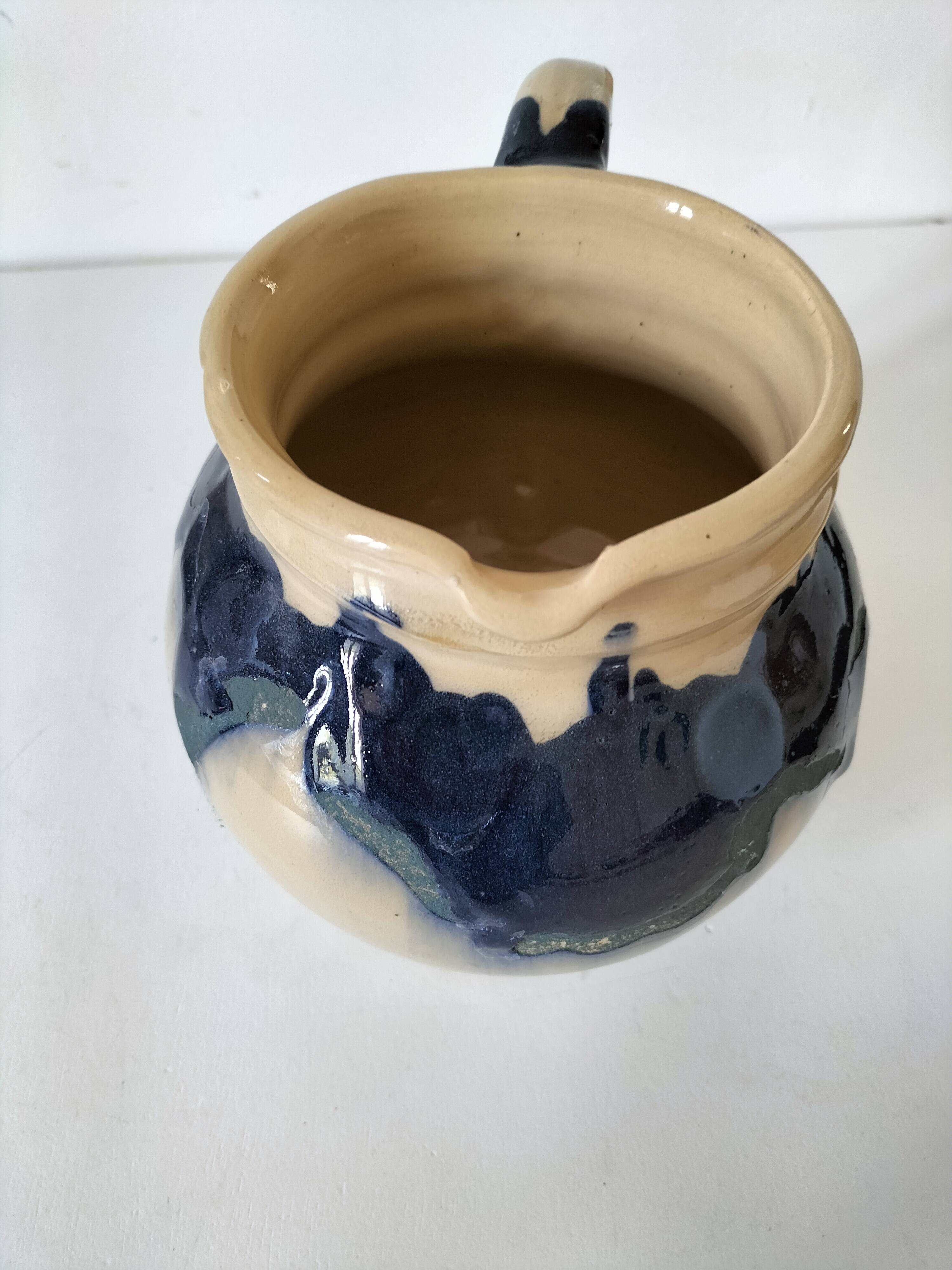handcrafted ceramic jug with navy blue drip glaze.