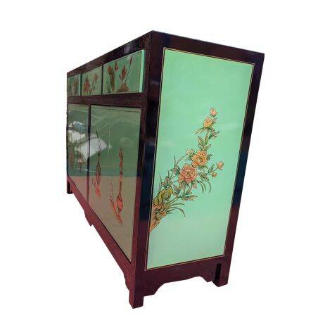 Lacquered buffet in soft green with floral patterns.