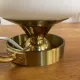 Table lamp in gold metal and opaline.