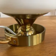 Table lamp in gold metal and opaline.