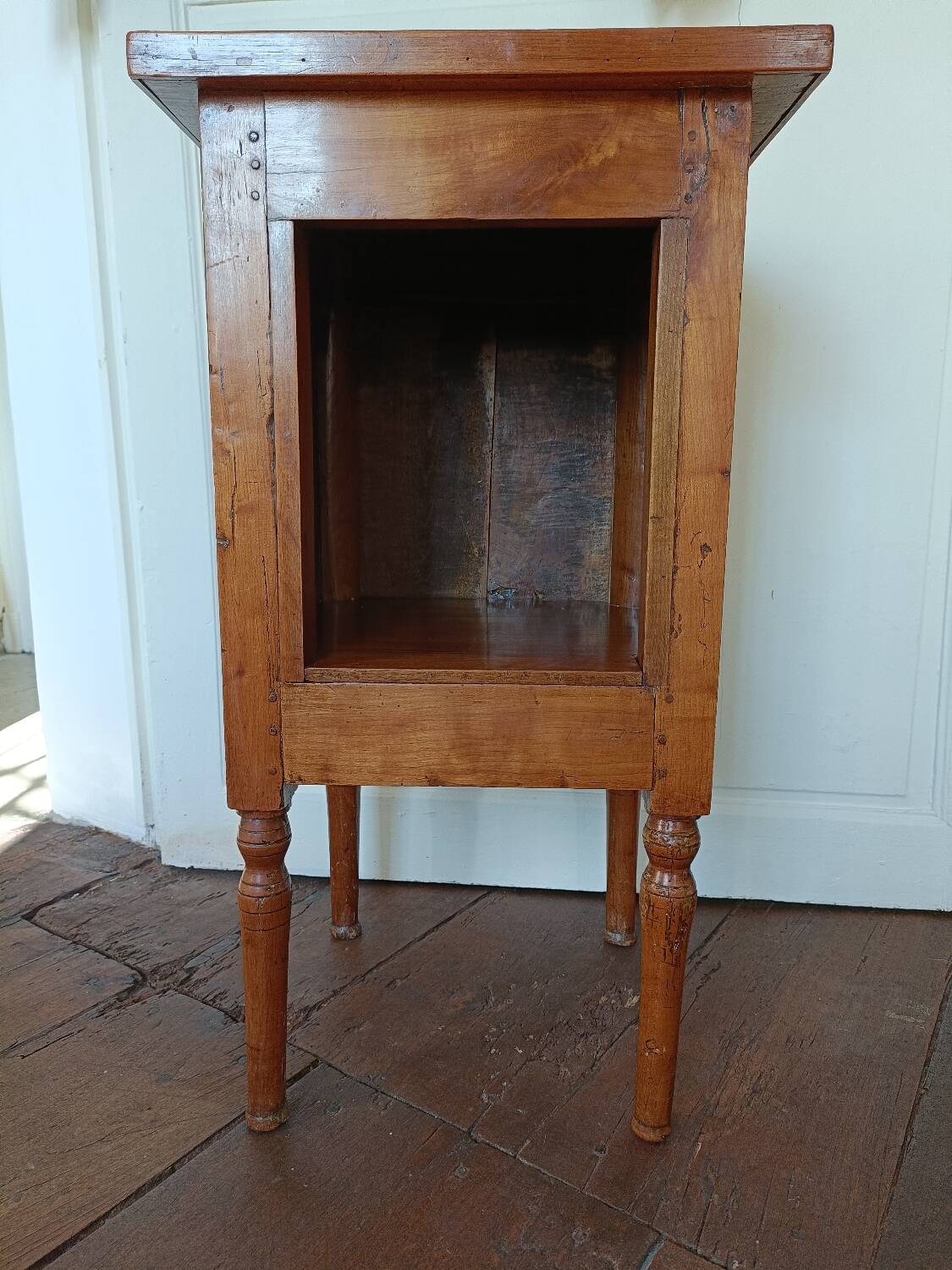Open wooden bedside table