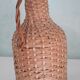 Bottle in his suit of wicker