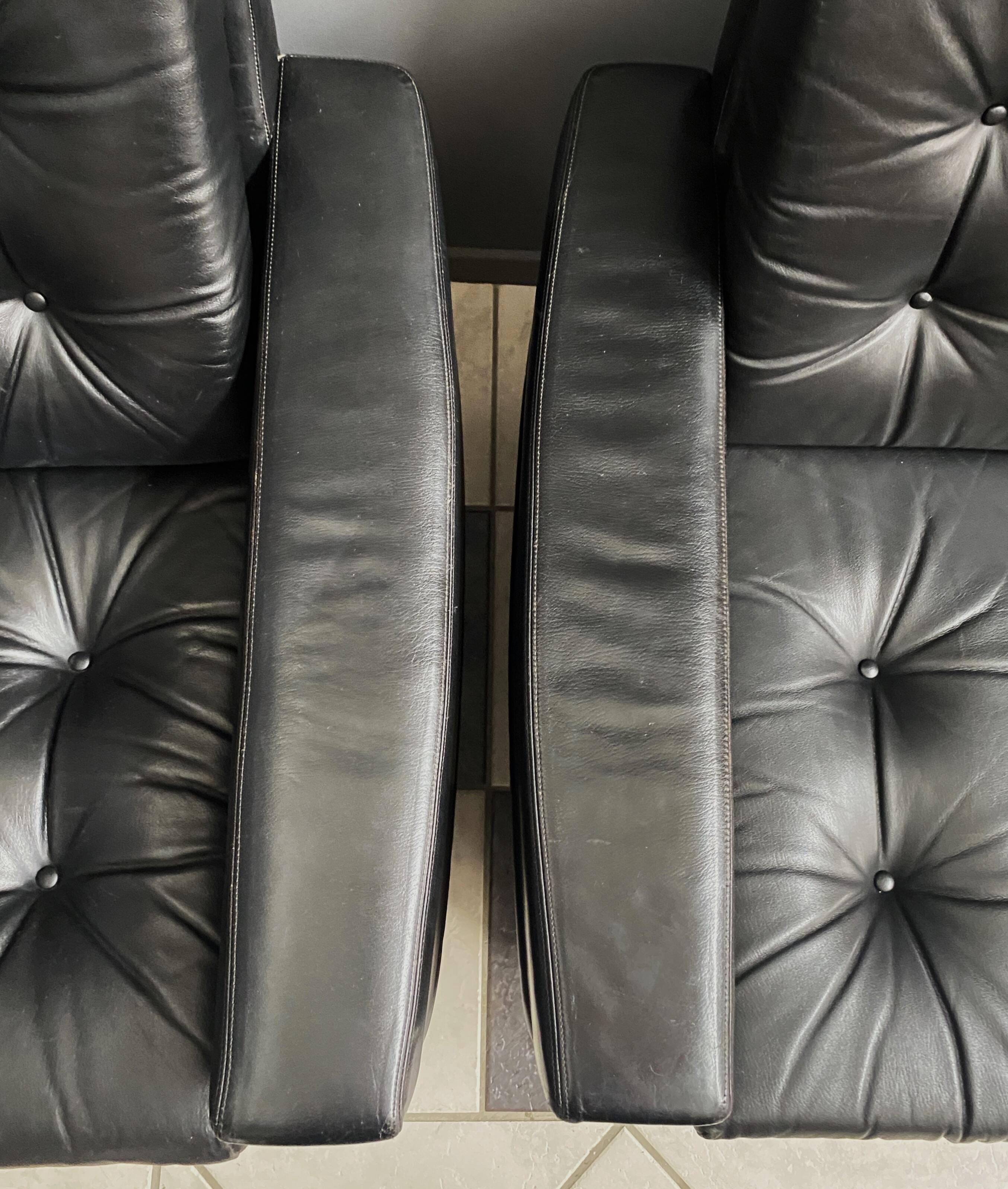 2 Black leather arm chairs 1960s on wheels