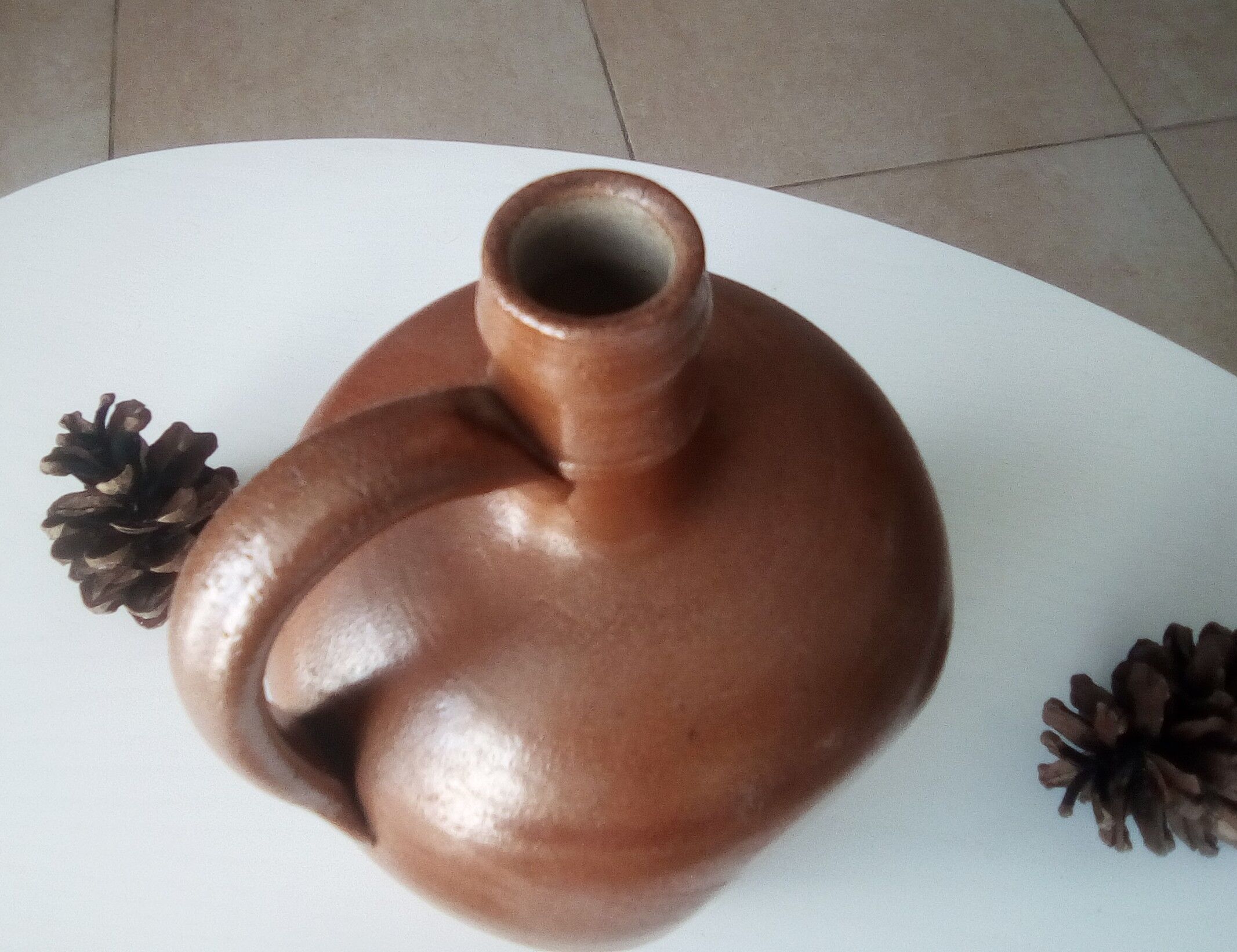 Old pitcher pitcher in varnished sandstone