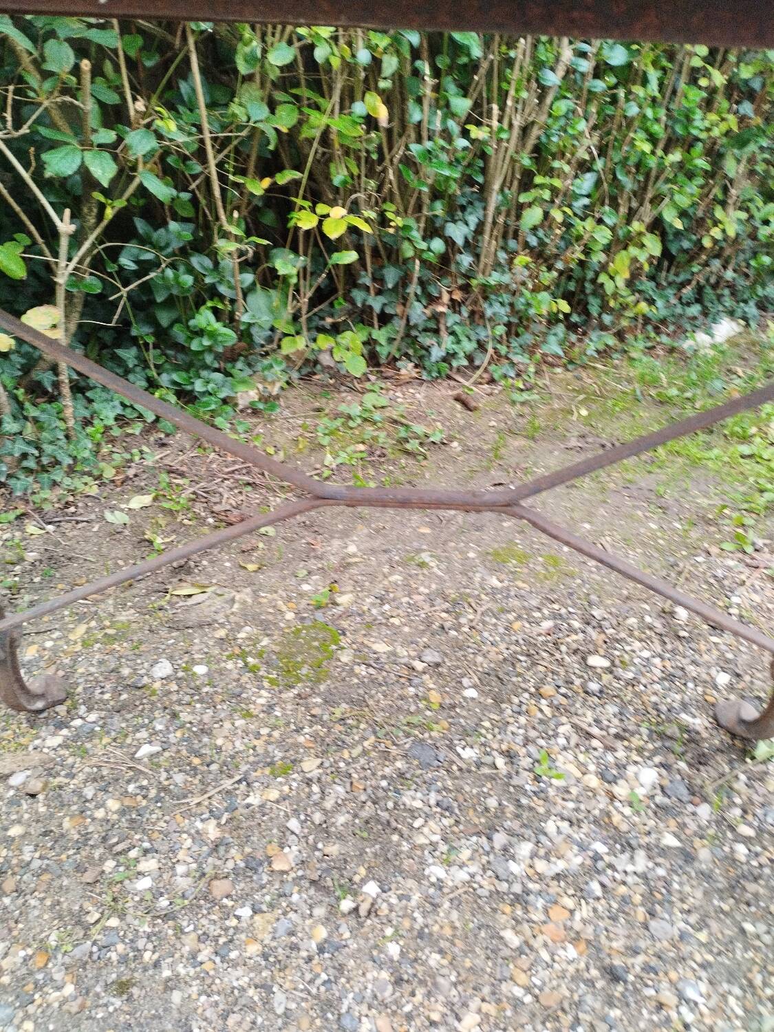 Antique bistro table with iron legs and wooden top