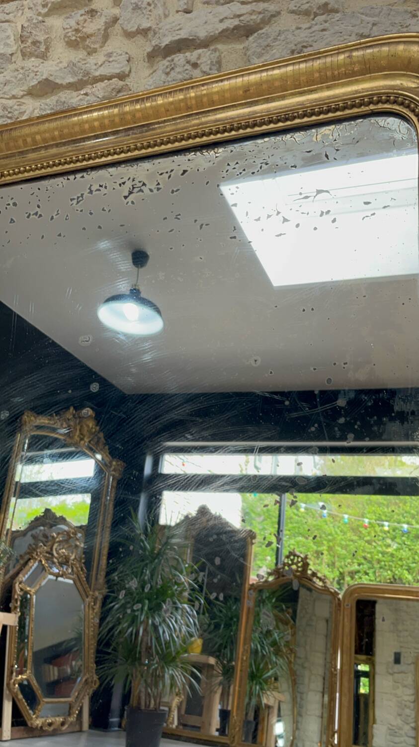 Louis-Philippe mantel mirror 133cm/115.5cm beaded gilded with gold leaf geometric decoration, late 19th century, heavily pitted and scratched glass, parquet on the back.