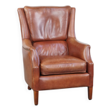 Cowhide armchair in good condition, finished with decorative nails