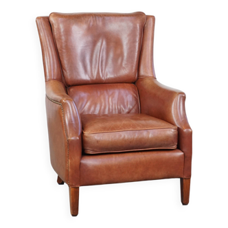Cowhide armchair in good condition, finished with decorative nails