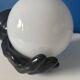 Vintage wall sconce with black hand and white opaline glass globe, 1970s L