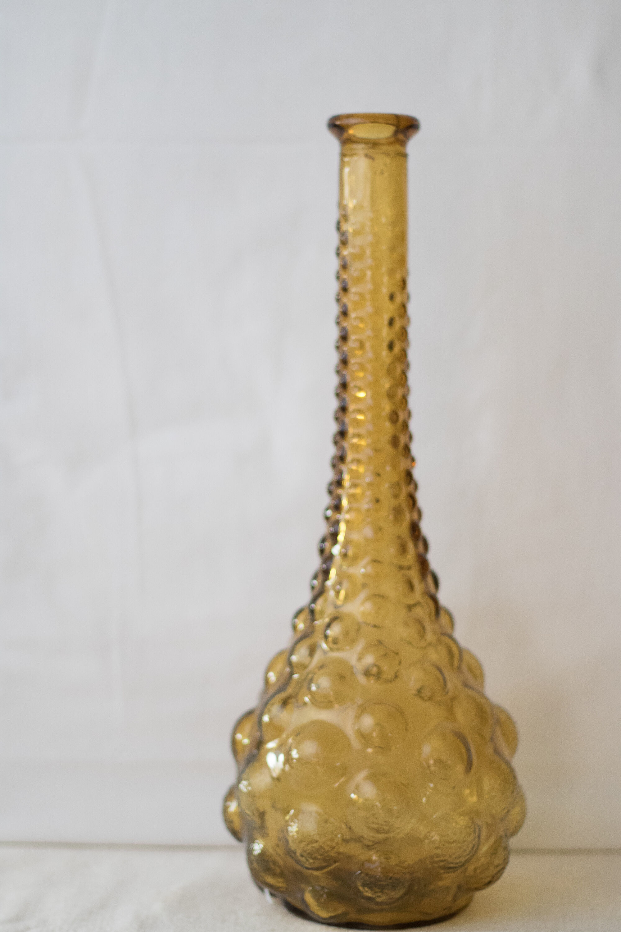 Green yellow bubble glass bottle