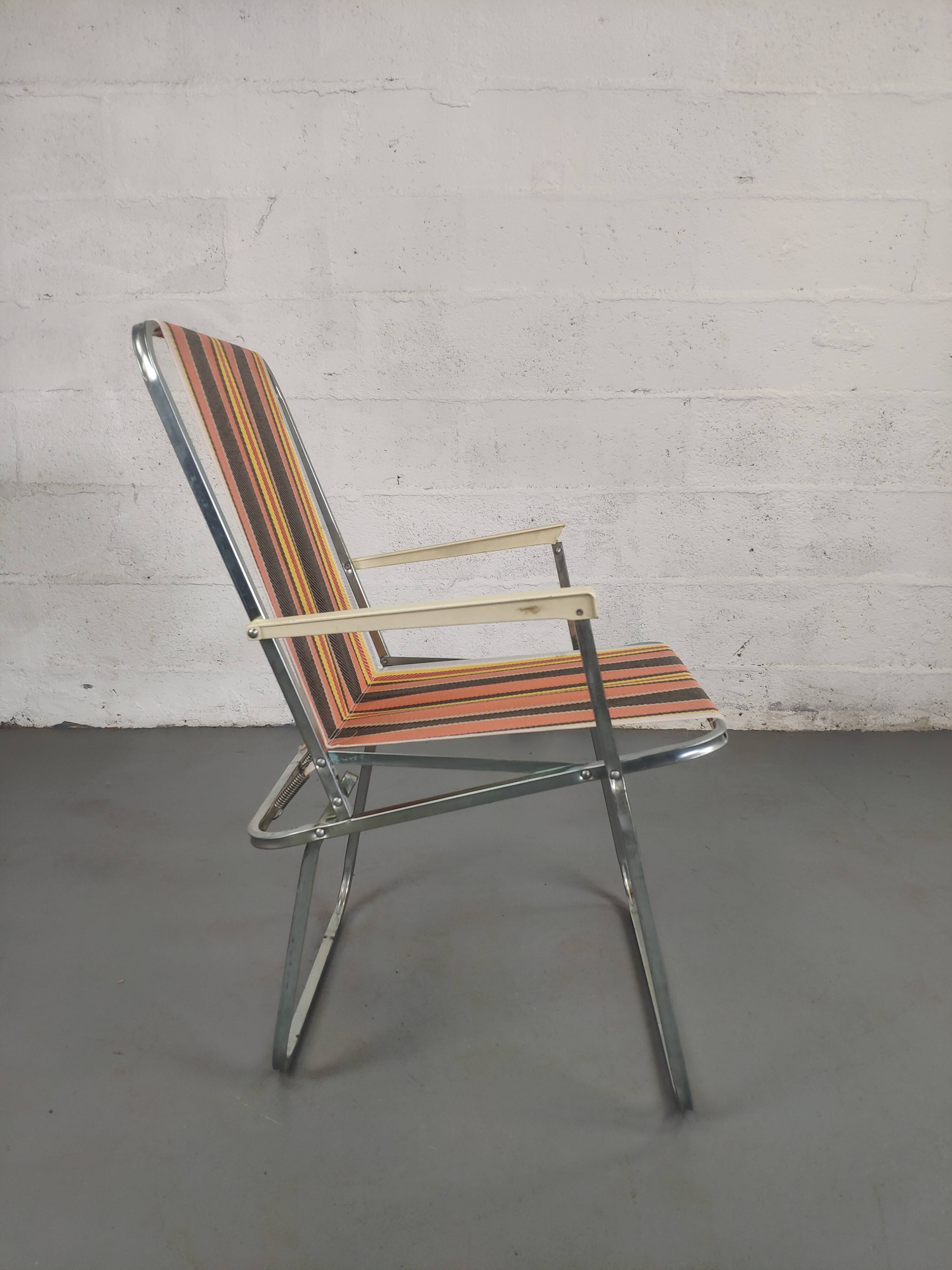 Old folding armchair seaside vintage orange black yellow