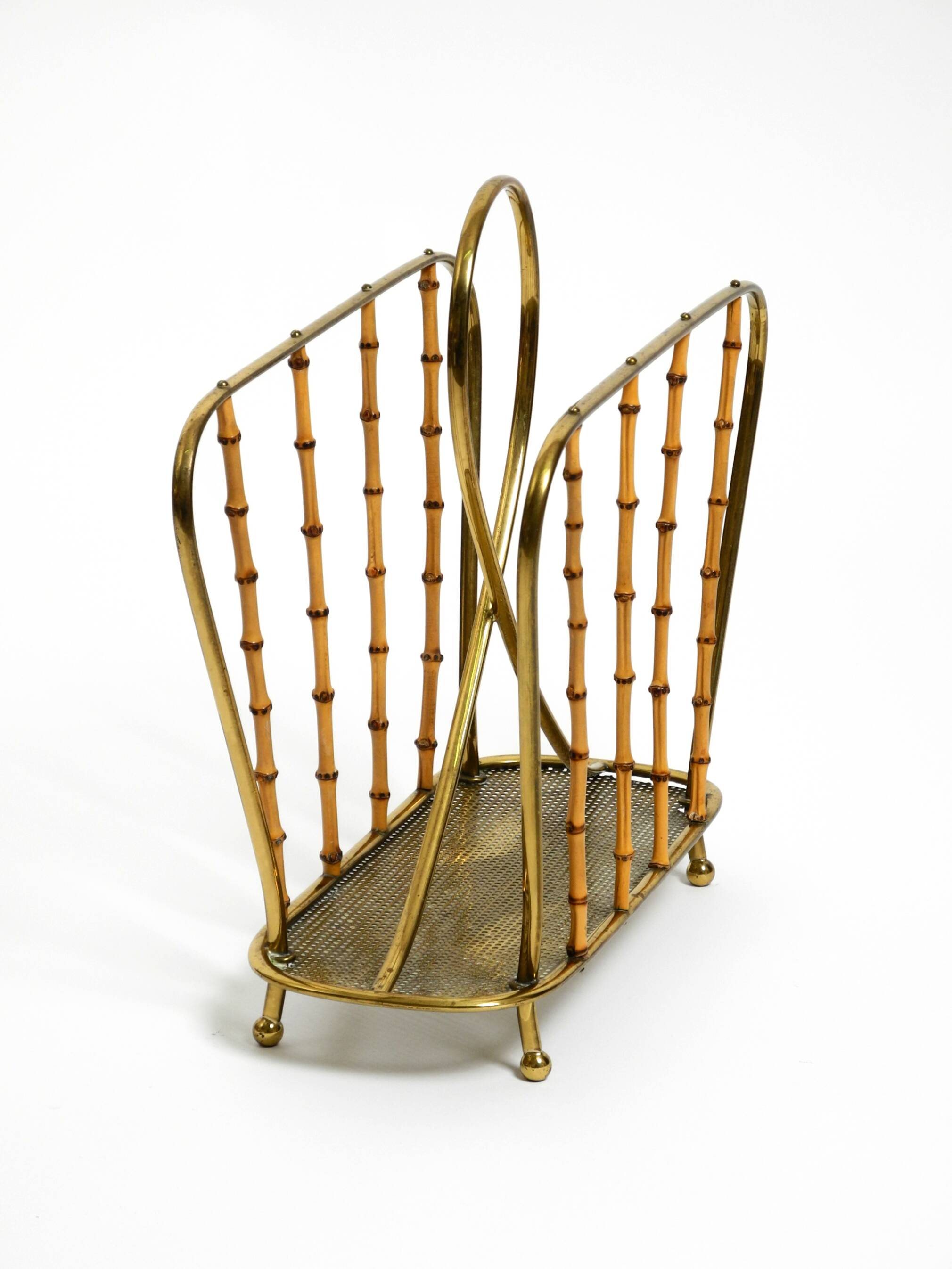 Rare Mid Century Modern magazine rack made of solid brass and genuine bambo