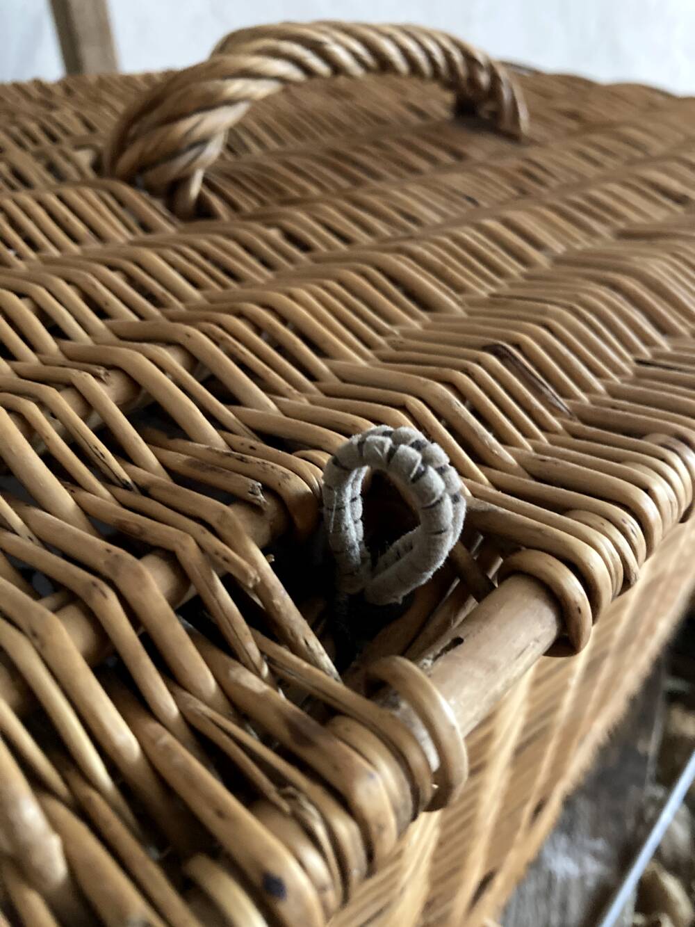 Antique wicker basket with closure and handle