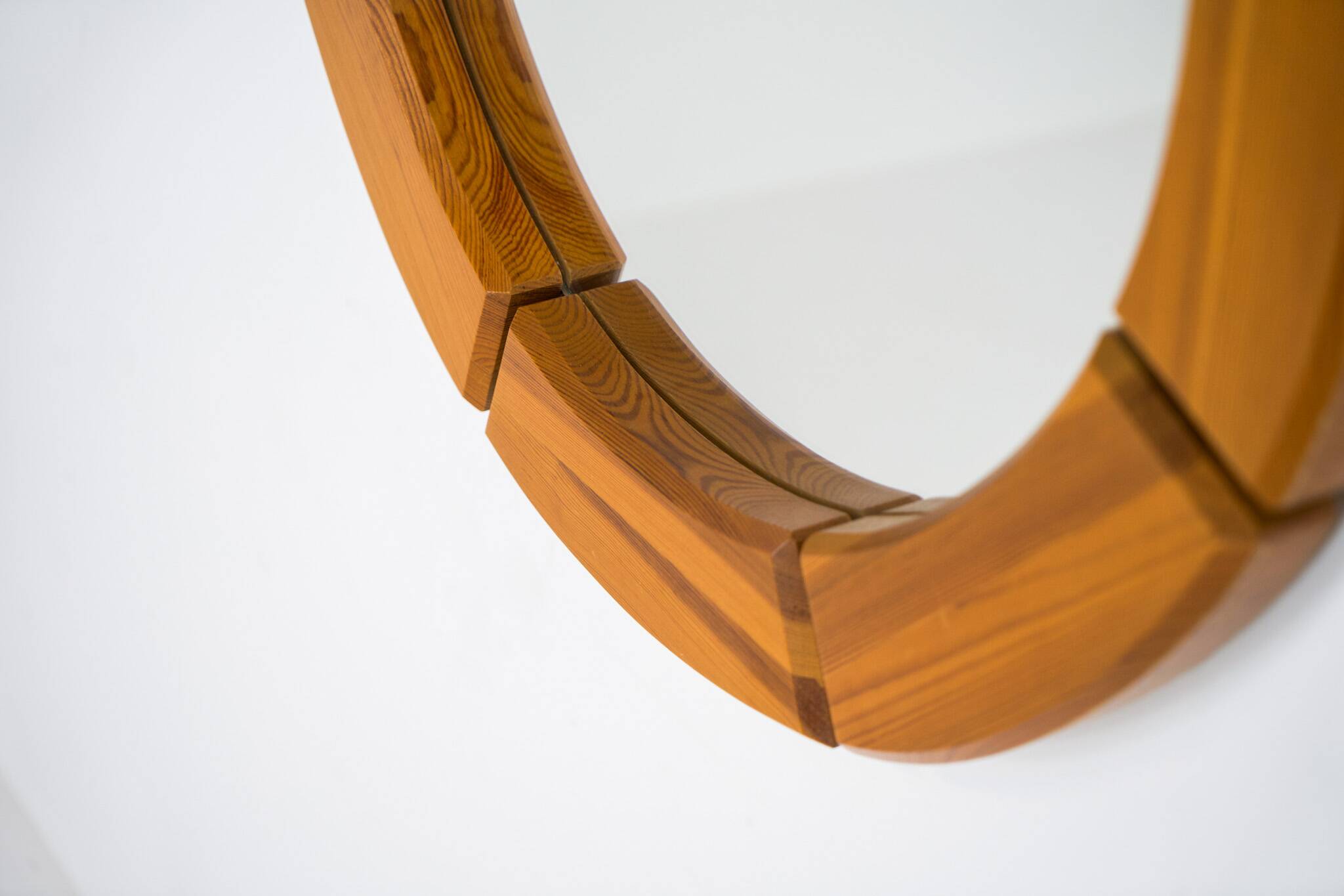 Sculptural wall-mirror in solid pine