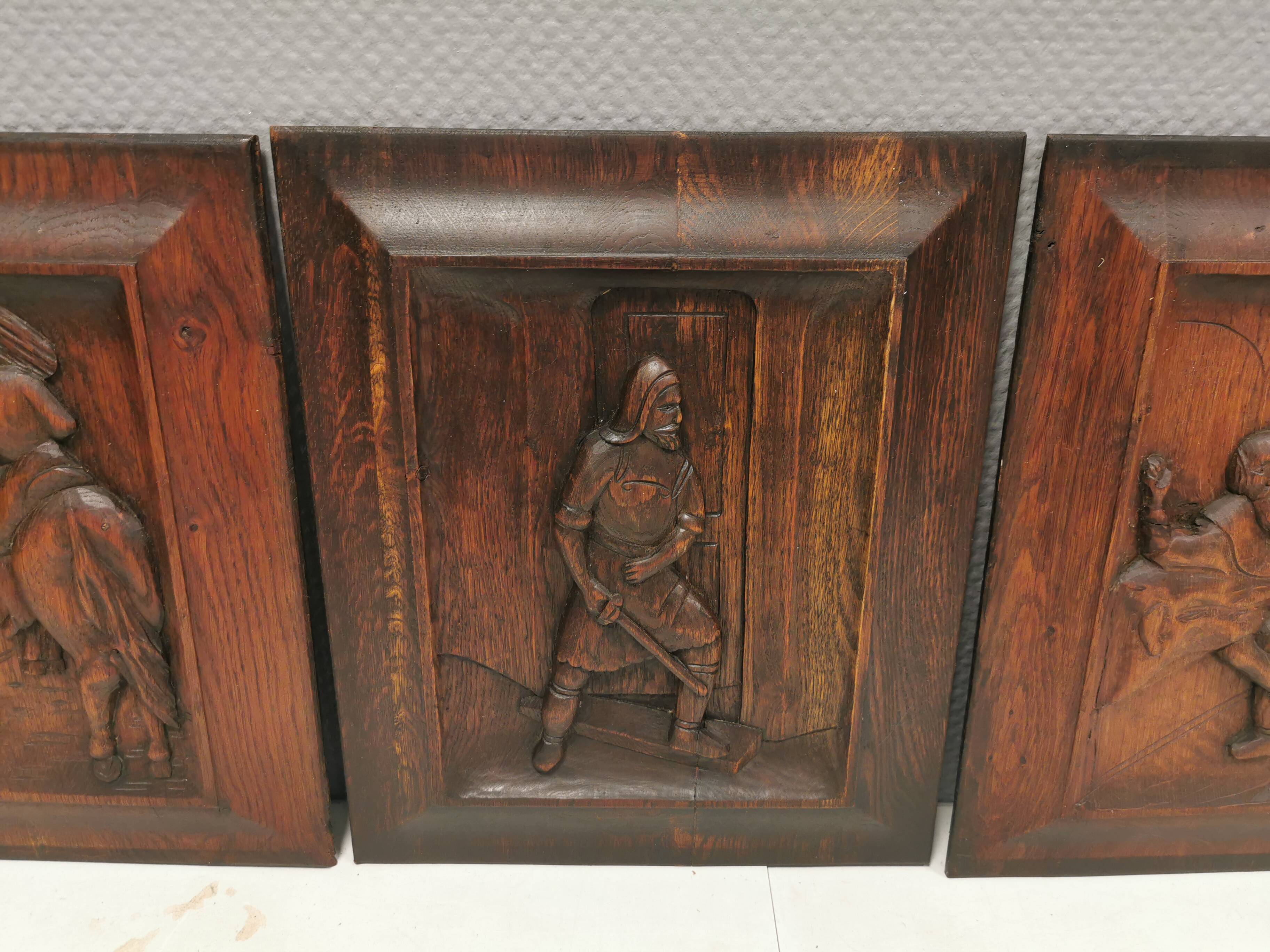 Four old wooden carvings to hang on the wall.