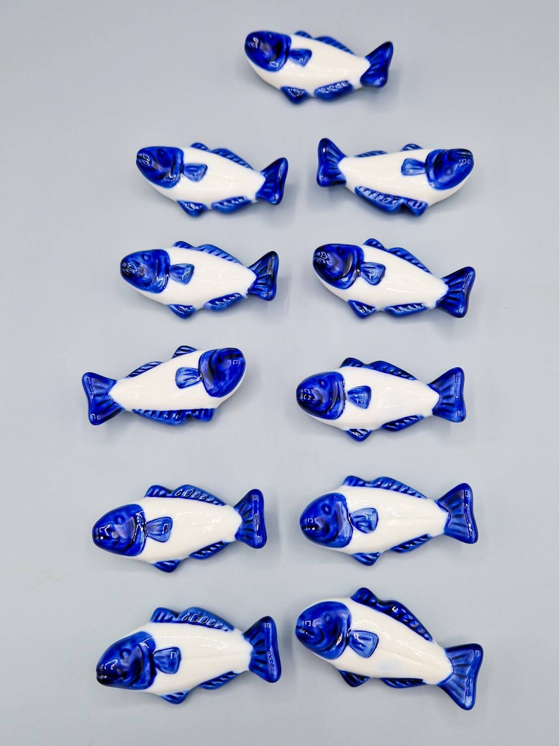 Set of 11 vintage blue and white porcelain fish knife rests.