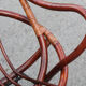 Rattan shell armchair with metal feet