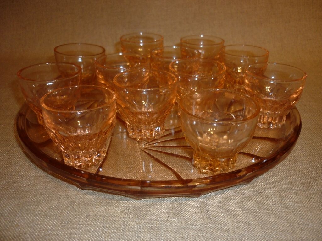 12 shot glasses on pink glass tray
