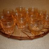 12 shot glasses on pink glass tray
