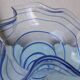 Glass vase on a pedestal with a blue trim.
