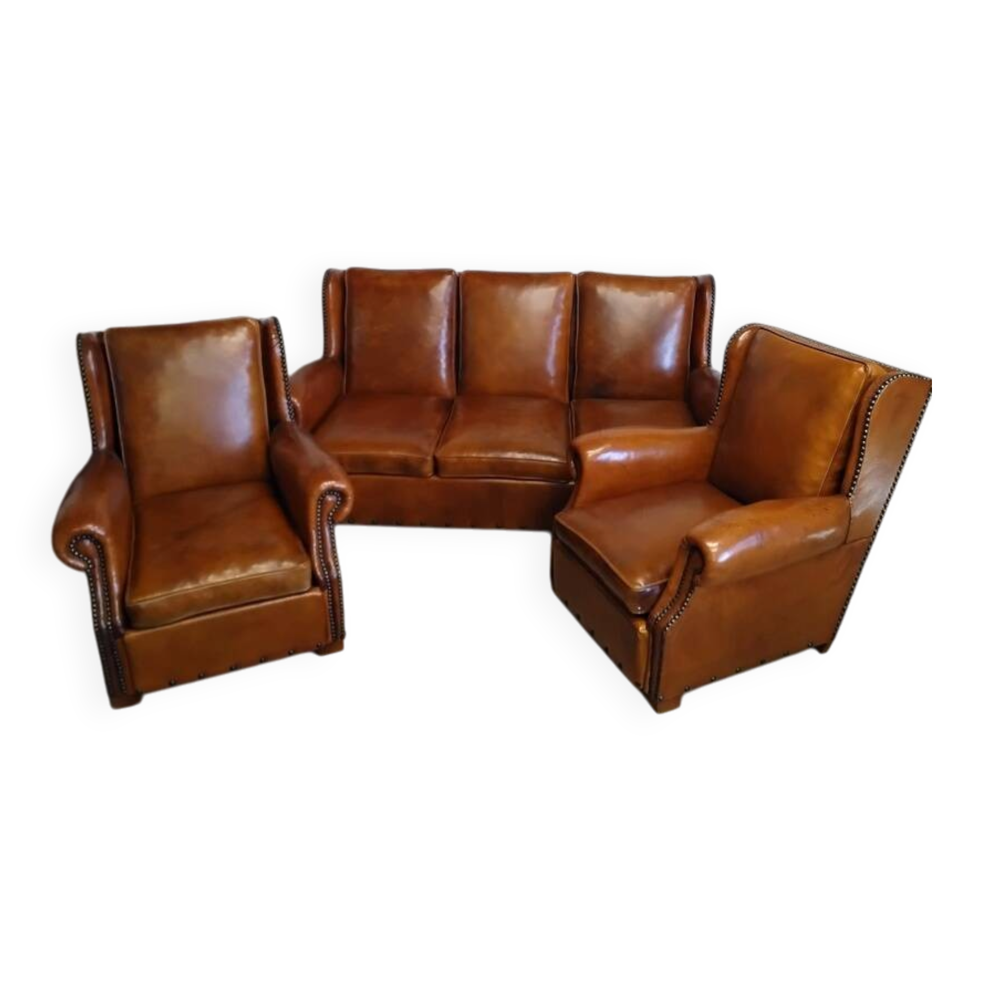 Living room with a sofa and wingback armchairs.