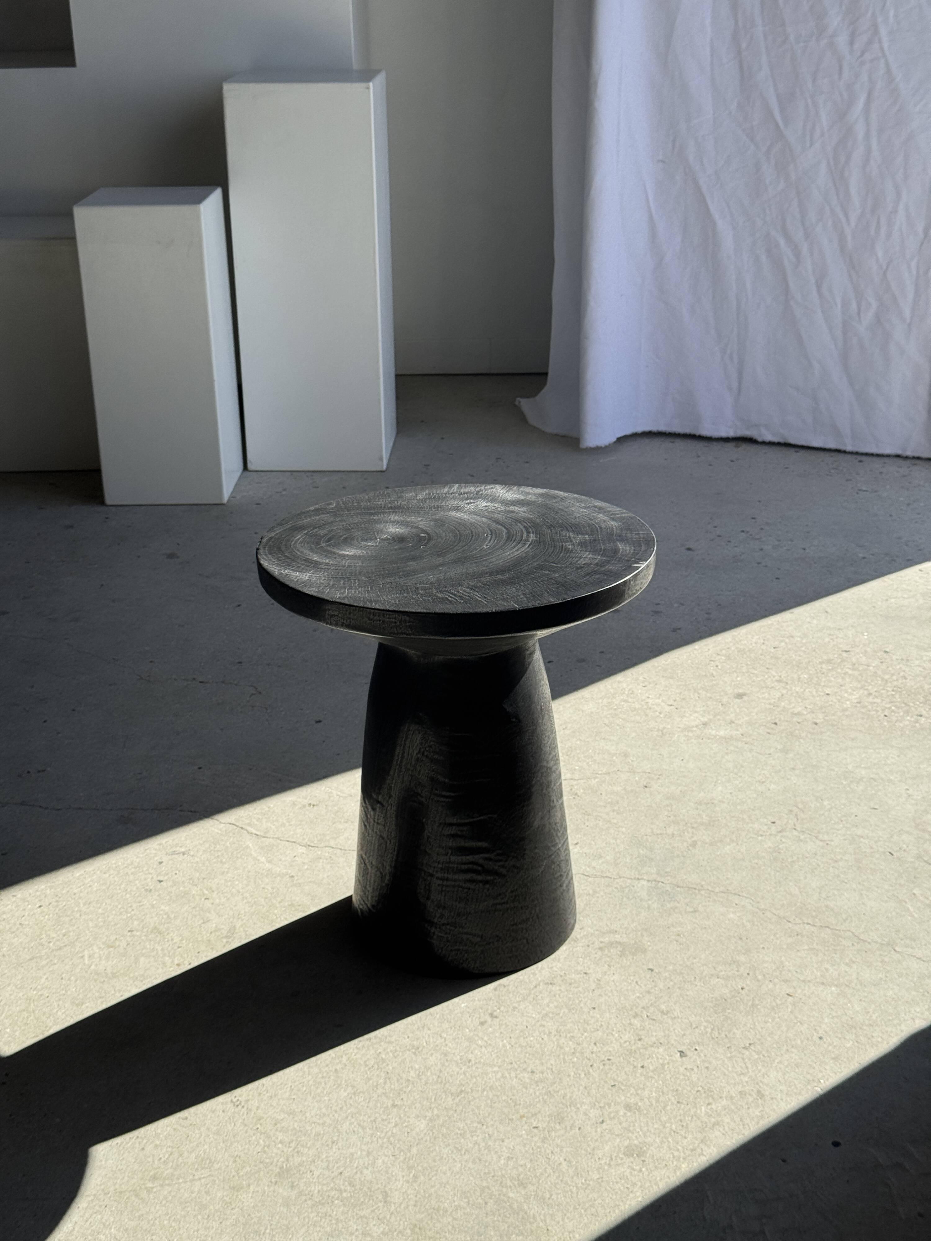 Black solid mango side table (monoxyle) with conical legs