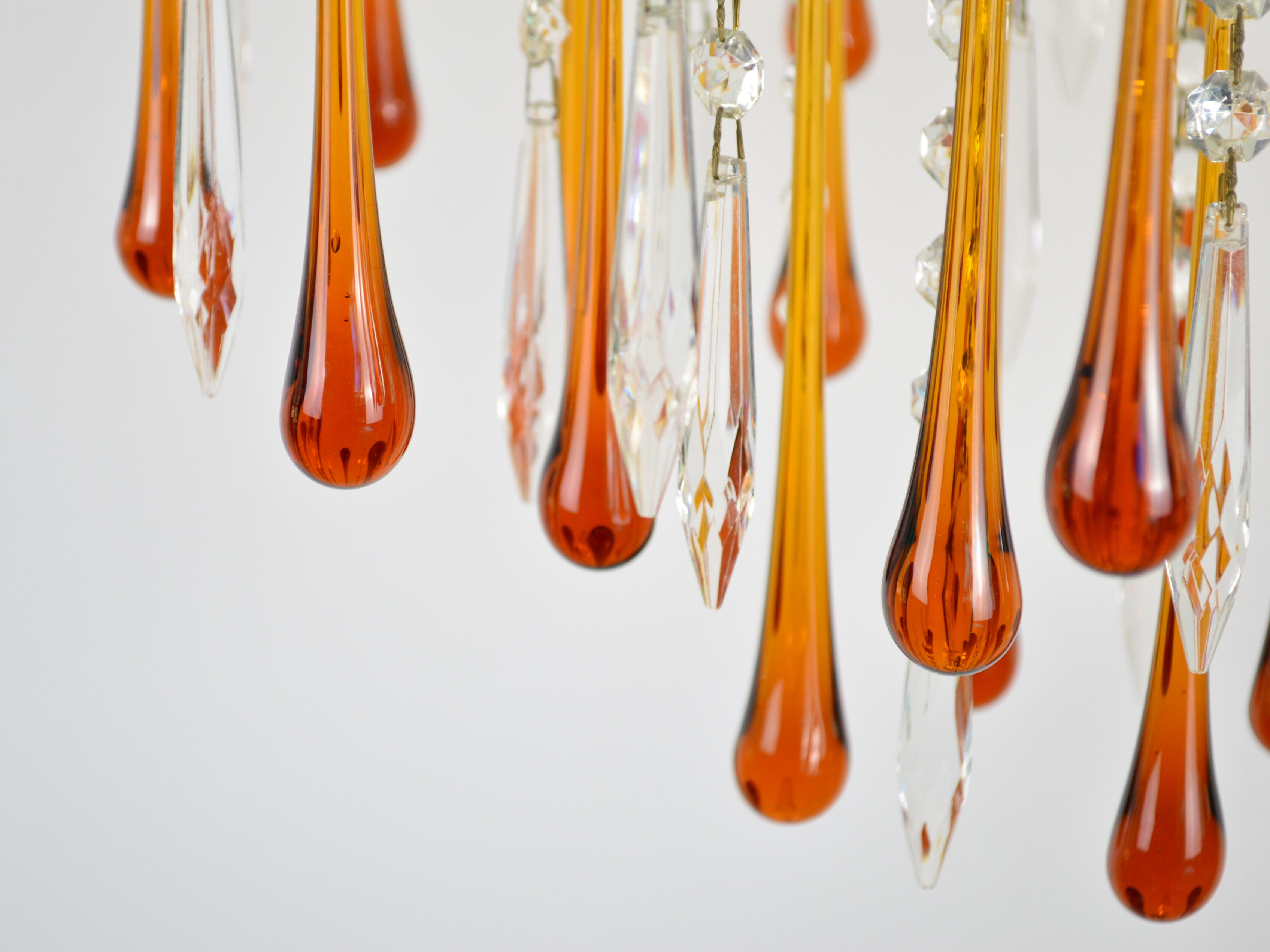 A pair of Mid Century 70's waterfall chandeliers. Murano glass amber drops. Paolo Venini style.