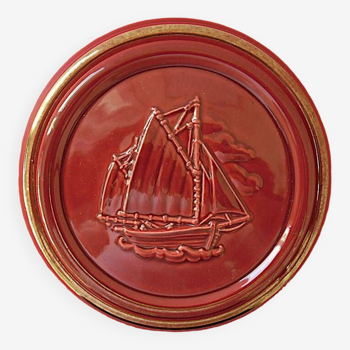 Red glazed earthenware candy box enhanced with gold decorated with a sailboat