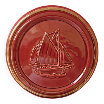 Red glazed earthenware candy box enhanced with gold decorated with a sailboat