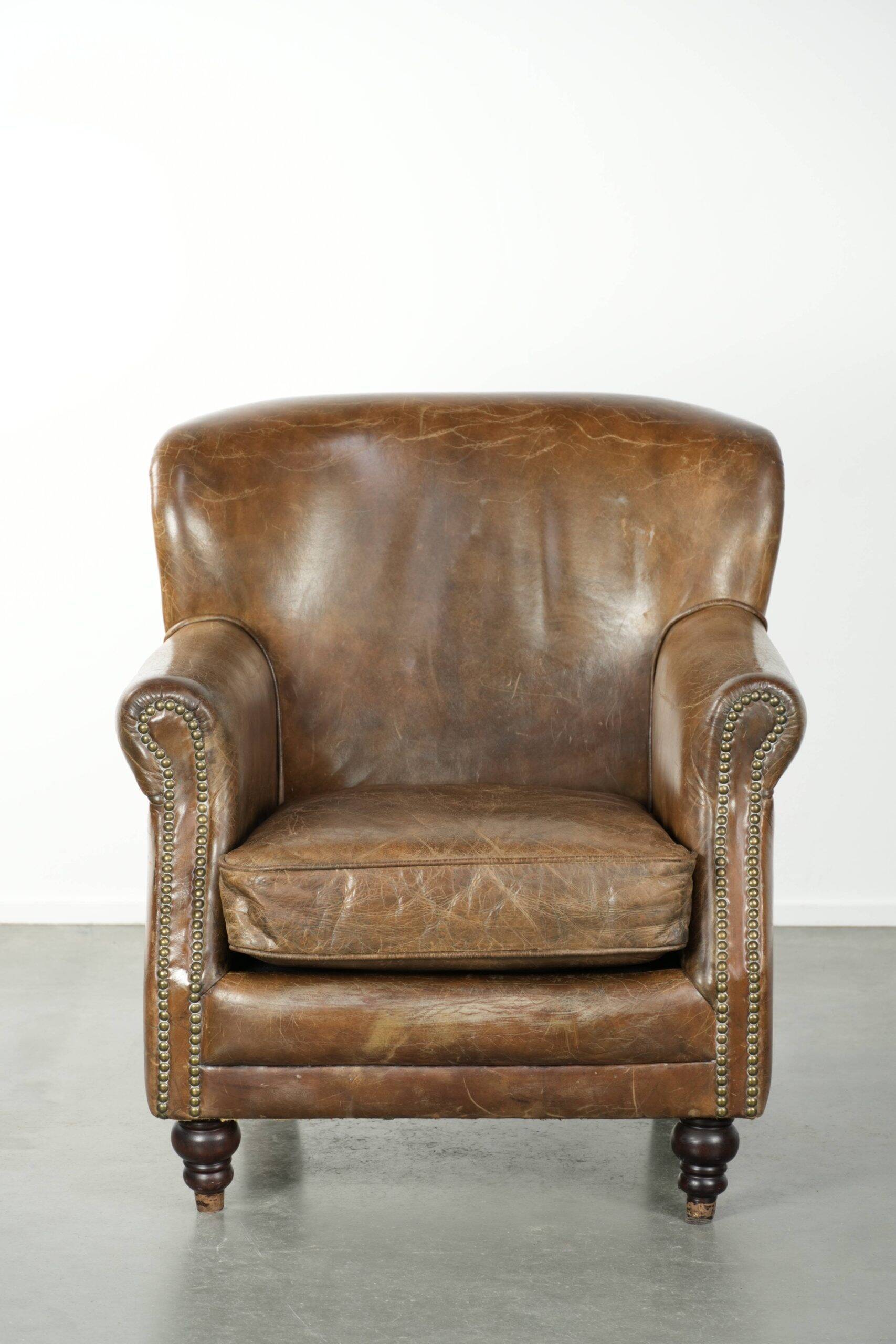 Robust cowhide armchair in a beautifully subtle size with a wonderful patina.