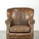 Robust cowhide armchair in a beautifully subtle size with a wonderful patina.