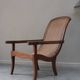 Fauteuil avec assise en cannage et accoudoirs pivotants