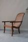 Fauteuil avec assise en cannage et accoudoirs pivotants