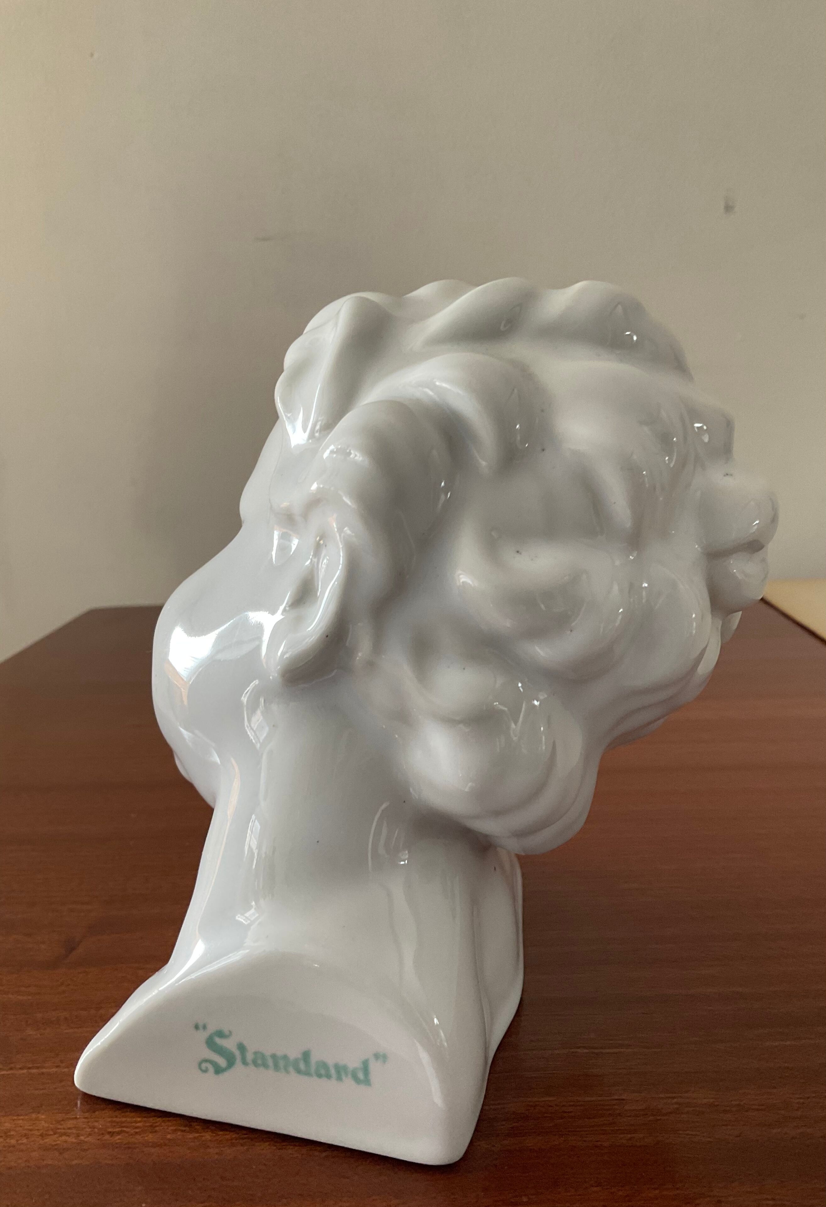 Cherub child bust in enamelled porcelain