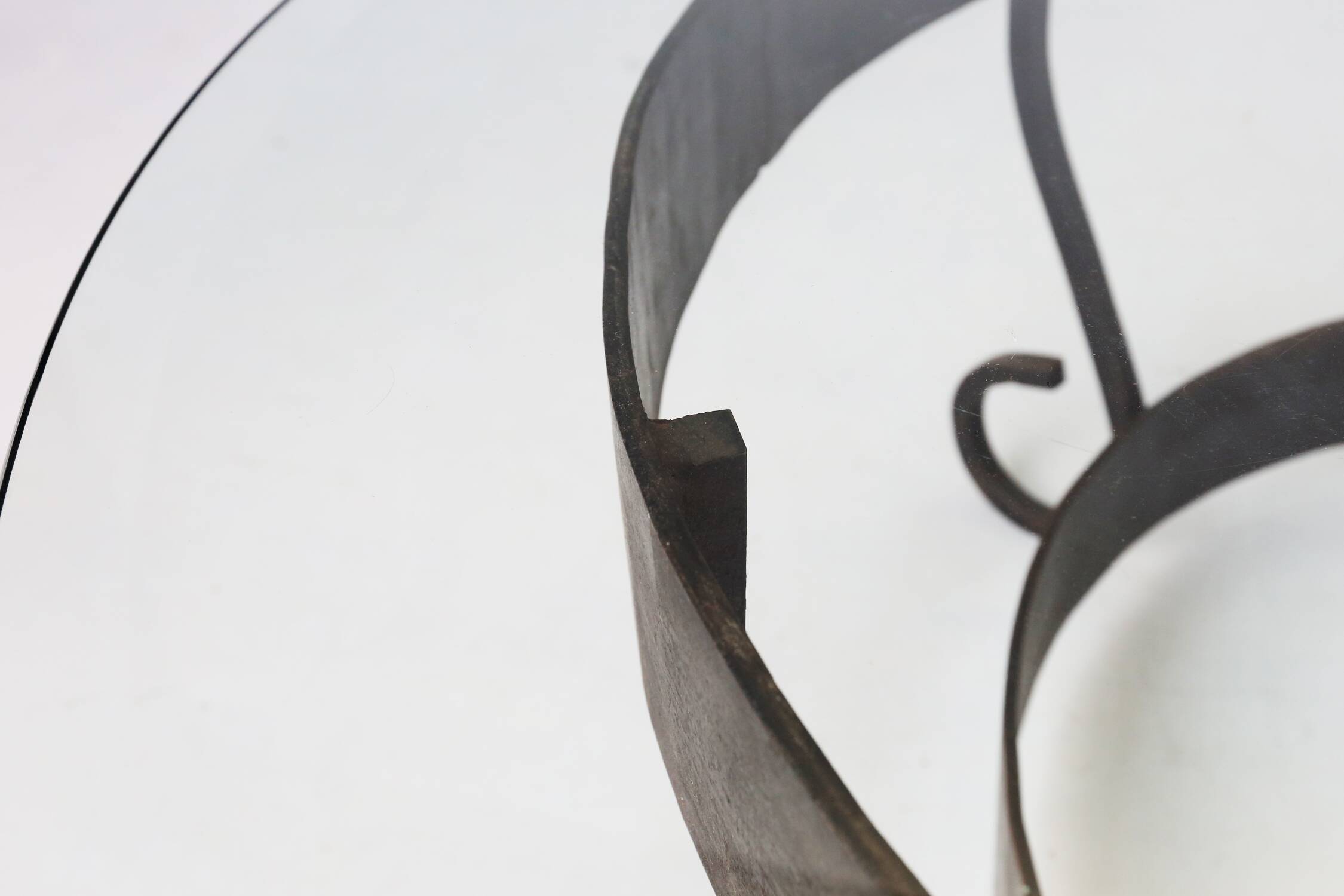 Rustic round coffee table with wrought iron base and glass top, France, 1930s