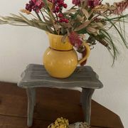 Small footrest bench in solid wood with a slate grey patina.