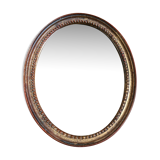 Old oval mirror in gilded wood