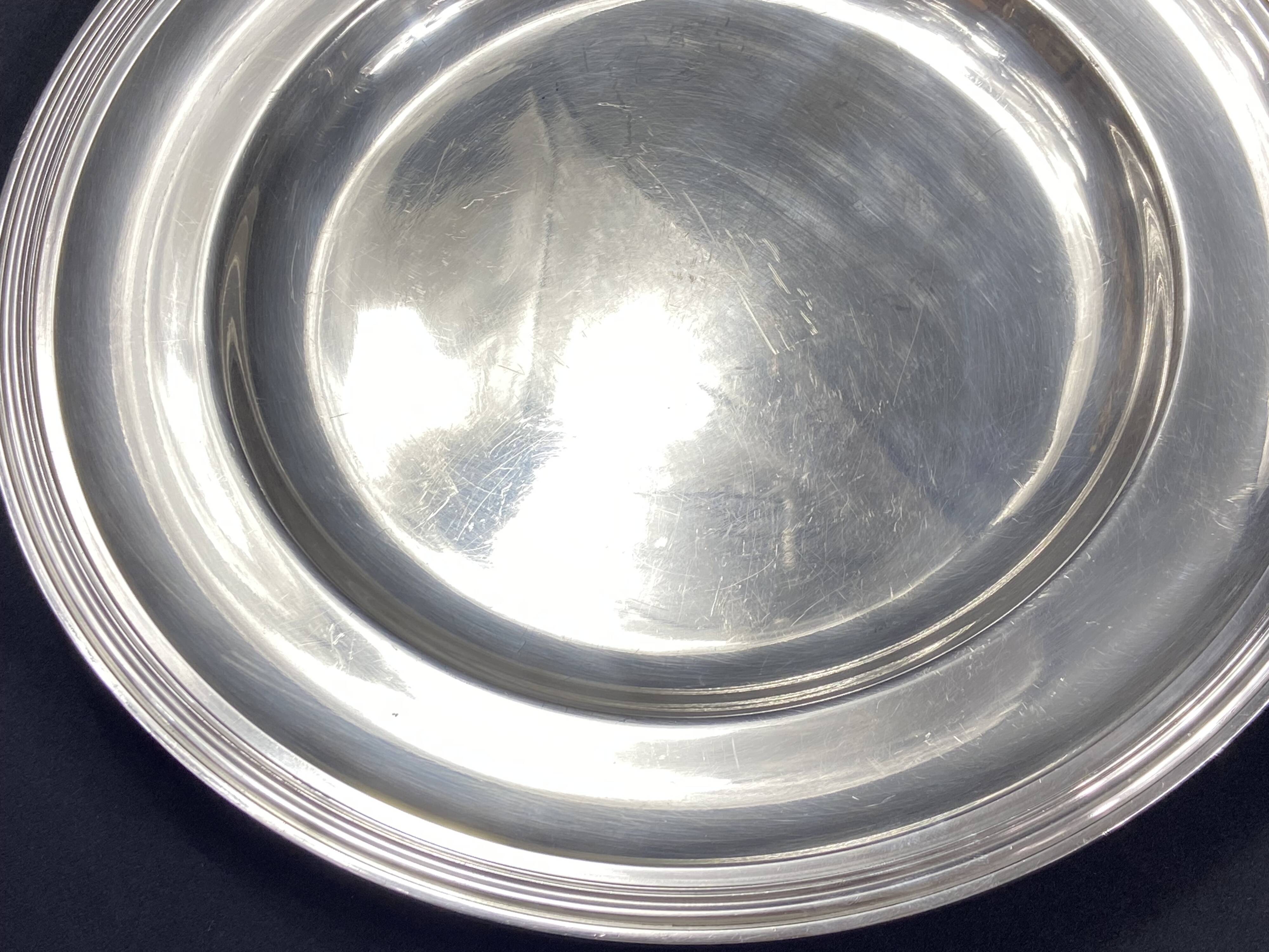 Circular silver-plated metal dish signed ercuis