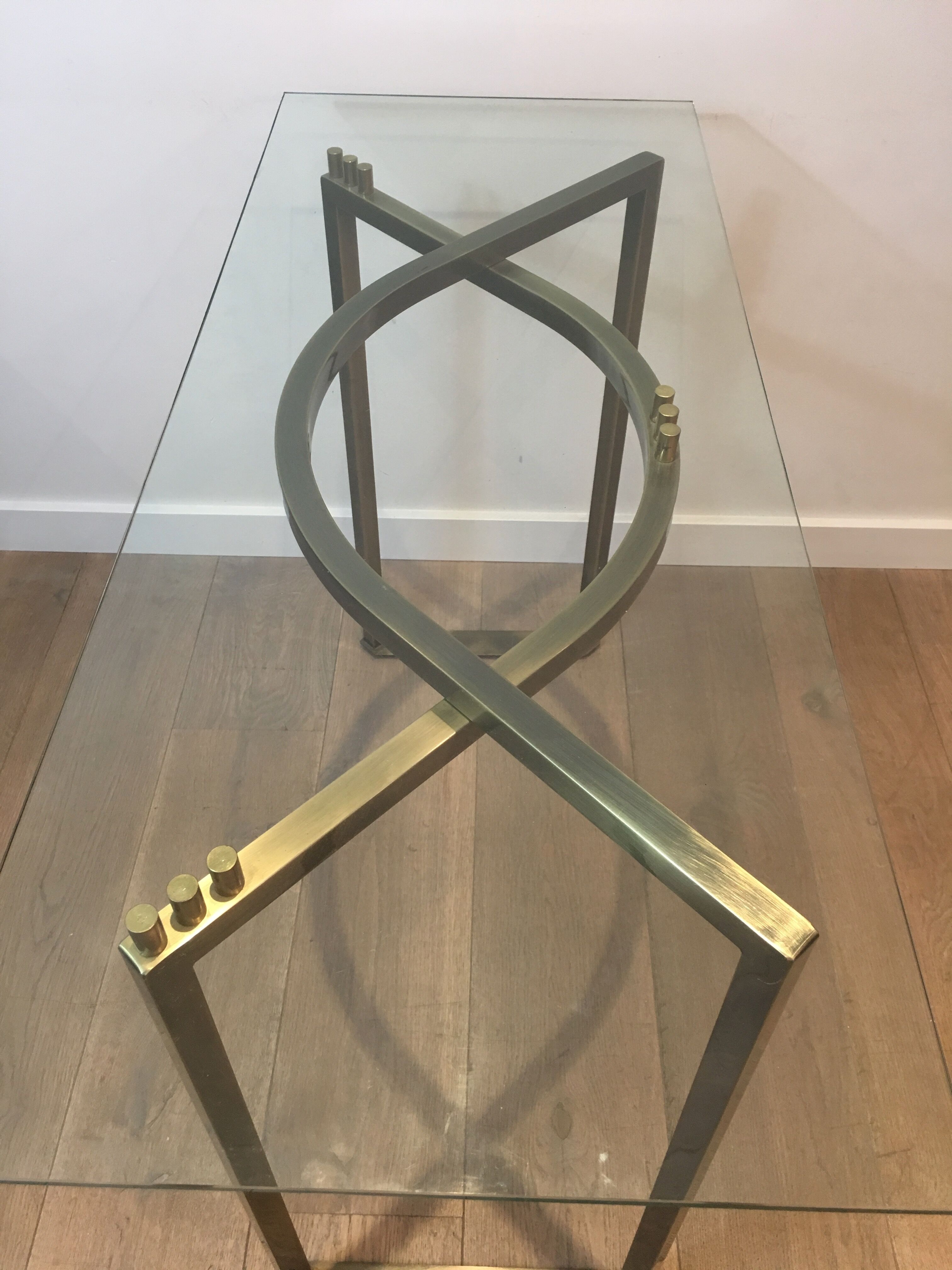 Console in brushed steel and brass and tray formed of a glass slab. French work. Around 1970