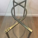 Console en acier brossé et laiton et plateau formé d'une dalle de verre. Travail français. Vers 1970